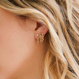 woman wearing a Zoë Chicco 14k Gold 3 Prong Diamond Large Curb Chain Drop Earring and a  Prong Diamond Small Curb Chain Huggie Earring in one ear