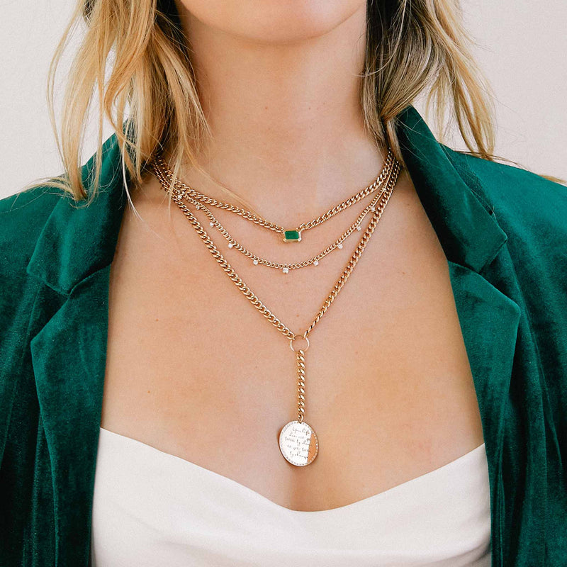 Woman in a white top wearing a green velvet blazer and wearing a Zoë Chicco 14k Gold 11 Graduated Prong Diamond Small Curb Chain Necklace layered with two other necklaces