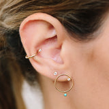 close up of woman's ear wearing Zoë Chicco 14kt Gold Small Circle Diamond Stud Earrings with Dangling Turquoise