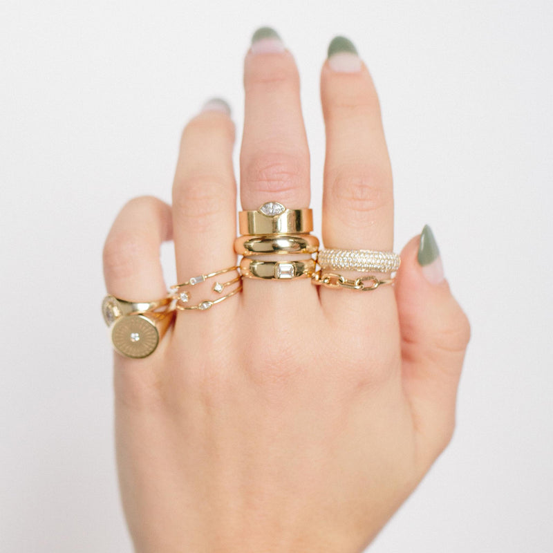 woman's hand wearing Zoë Chicco 14kt Gold Square Oval Link Chain Ring stacked with other rings