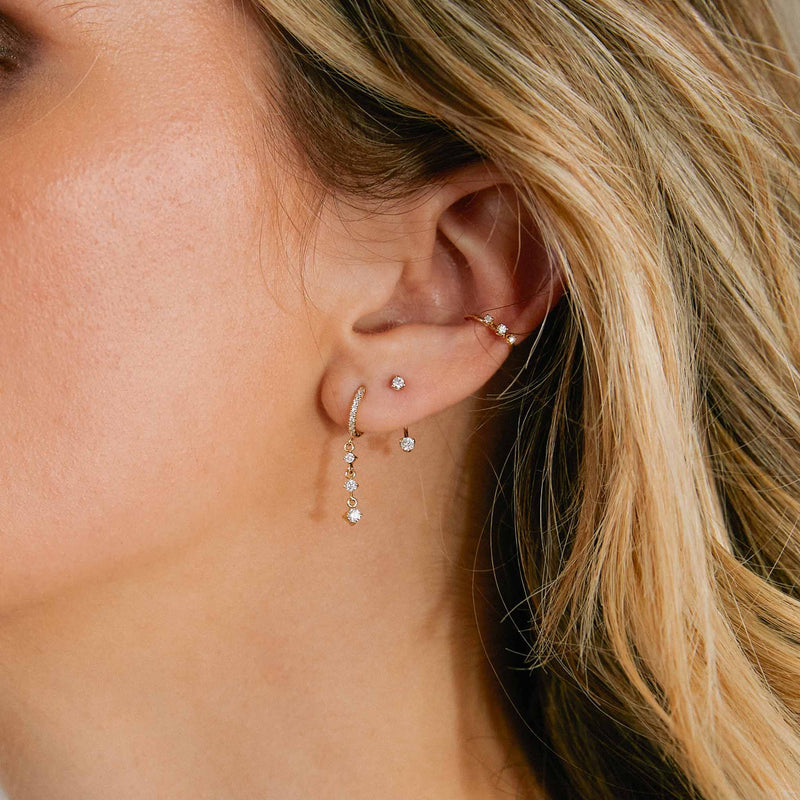 woman wearing a Zoë Chicco 14k Gold Mixed Round Diamond Stud Jacket Earring with a diamond drop earring and a diamond earring cuff