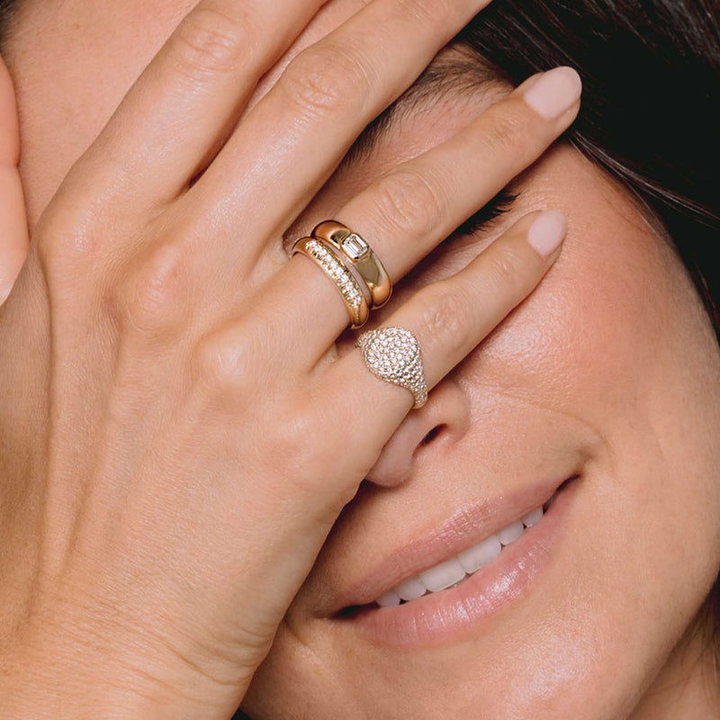 woman holding her hand up to her face wearing a Zoë Chicco 14k Gold 10 French Set Diamond Half Round Ring on her ring finger