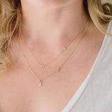 woman wearing Zoë Chicco 14kt Gold Itty Bitty New York Floating Heart Necklace with a Pave Diamond Lock and Key Necklace