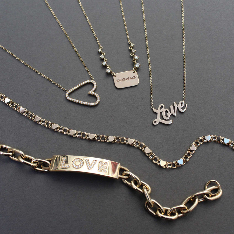 a Zoë Chicco 14k Gold Heart & Double Link Chain Necklace laid flat on a dark gray background