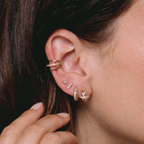close up of woman's ear wearing Zoë Chicco 14k Gold 3 Prong Diamond Bar Stud Earring on her ear