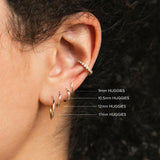 comparison image of four sizes of Zoë Chicco 14k Gold Hinge Huggie Hoop Earrings