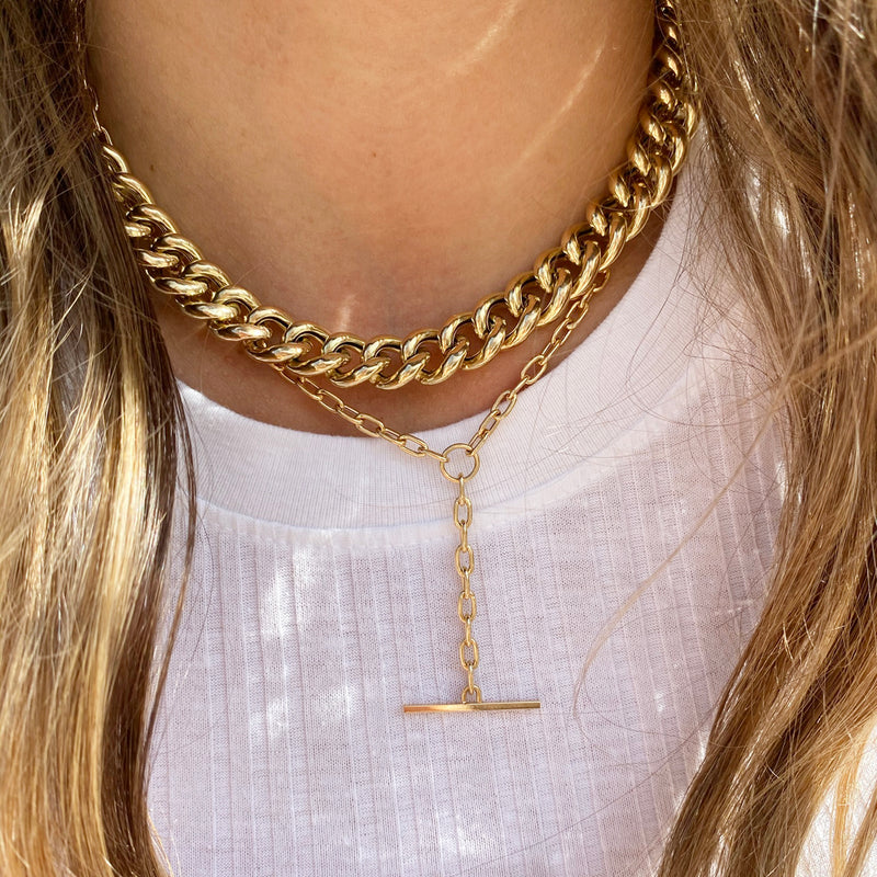 woman wearing Zoë Chicco 14kt Gold XXL Thick Link Curb Chain Necklace layered with a Square Oval Link Lariat Toggle Necklace