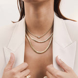 woman in a cream blazer wearing a Zoë Chicco 14k Gold Medium Snake Chain Necklace layered with a Zoë Chicco 14k Gold Large Snake Chain Necklace