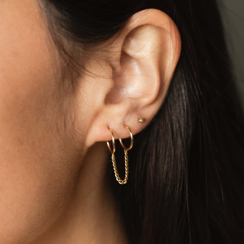 woman's ear wearing a Zoë Chicco 14k Gold Extra Small Curb Chain Double Huggie Hoop Earring