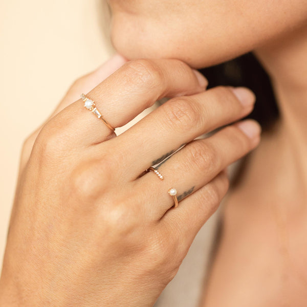 woman's hand wearing a Zoë Chicco 14k Gold Tiny Pearl & Pavé Diamond Open Ring on her ring finger