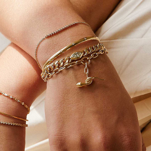 close up view of a woman's wrist wearing a Zoë Chicco 14k Gold One of a Kind 1.01 ctw Marquise Diamond Large Curb Chain Bracelet