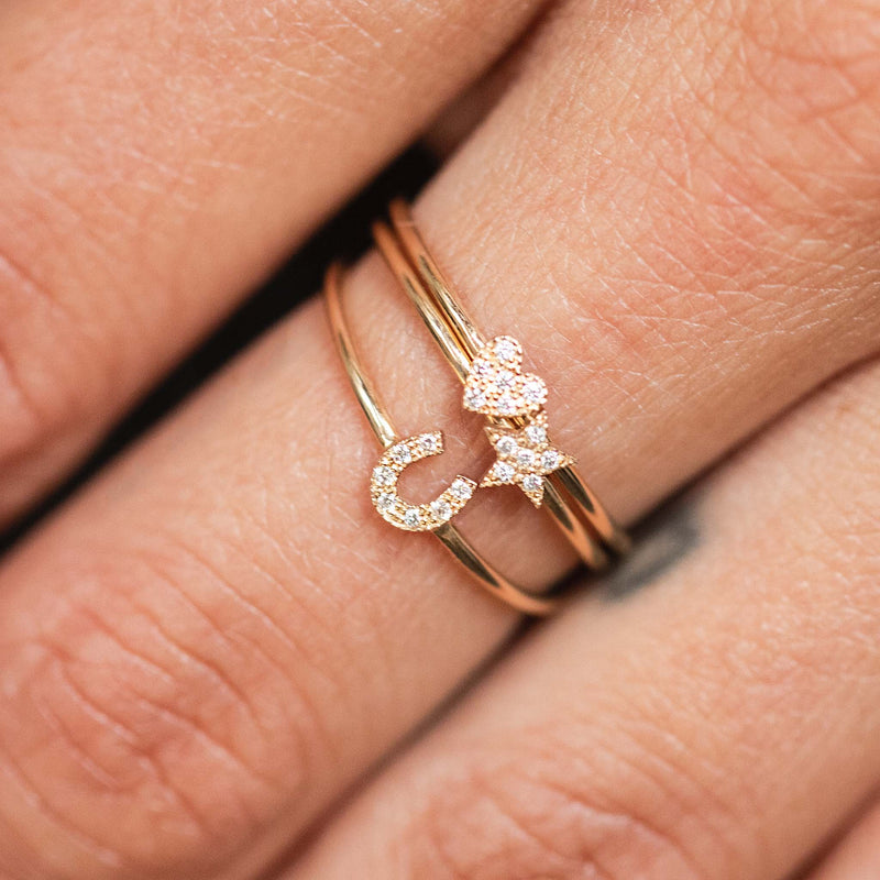 close up of woman's finger wearing a Zoë Chicco 14k Gold Itty Bitty Pavé Diamond Horseshoe Ring