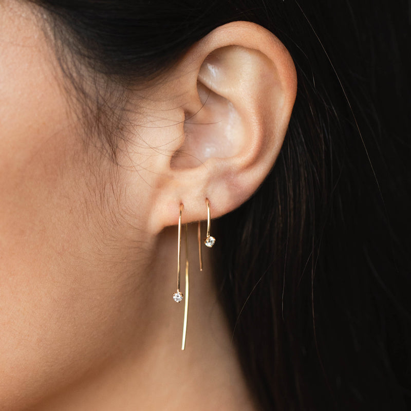 woman wearing a Zoë Chicco 14k Gold Large Prong Diamond Wire Threader Hook Earring and a Prong Diamond Short Wire Threader Earring