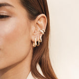 close up of woman wearing a Zoë Chicco 14k Gold 5 Diamond Chubby Ear Cuff layered with a Pave Diamond Wide Chubby Ear Cuff