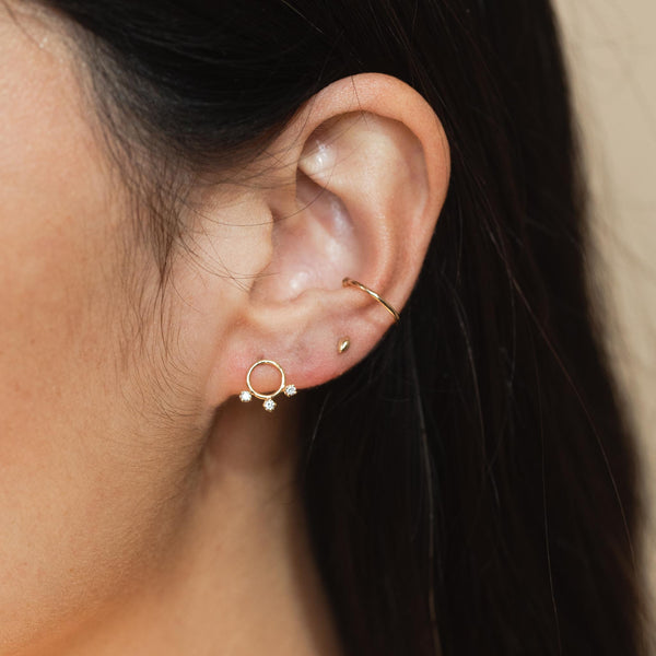 woman's ear wearing a Zoë Chicco 14k Gold 3 Prong Diamond Circle Stud Earring