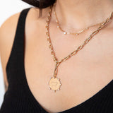 woman wearing an XL square oval link chain necklace with a swivel clasp linked into one of the links and a Zoë Chicco 14k Gold Medium "family first" Disc with Prong Diamonds Charm Pendant hanging from the bottom of the other end
