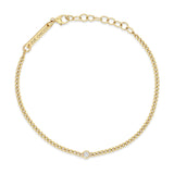 top down view of a Zoë Chicco 14k Gold Extra Small Curb Chain Bracelet with Floating Diamond