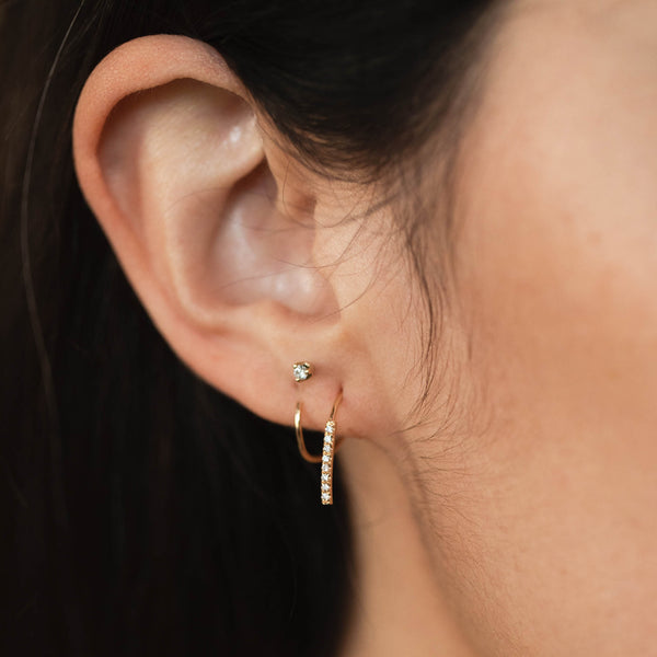close up of a woman's ear wearing a Zoë Chicco 14k Gold Pavé Diamond Bar Spiral Hoop Earring