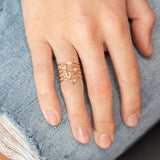 hand wearing a Zoë Chicco 14k Gold Itty Bitty Pavé Diamond Star Ring on her ring finger layered with other itty bitty rings