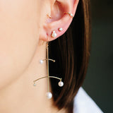 woman's ear wearing Zoë Chicco 14kt Gold Bezel Set Diamond Wire Ear Cuff