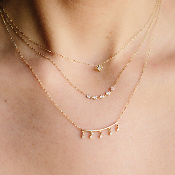 Three Zoe Chicco diamond bezel and gold necklaces layered 