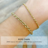 wrist with two different sizes of rope chain bracelets